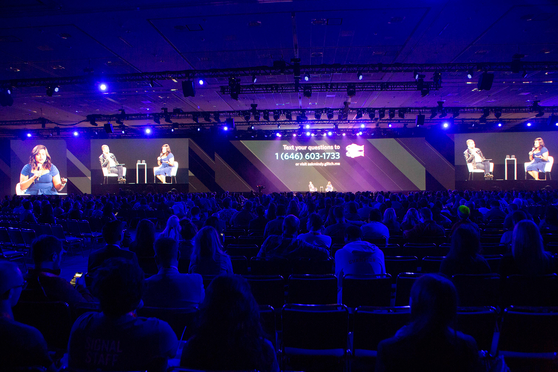 Massive keynote conference with thousands of attendees and panel visible on IMAG screens